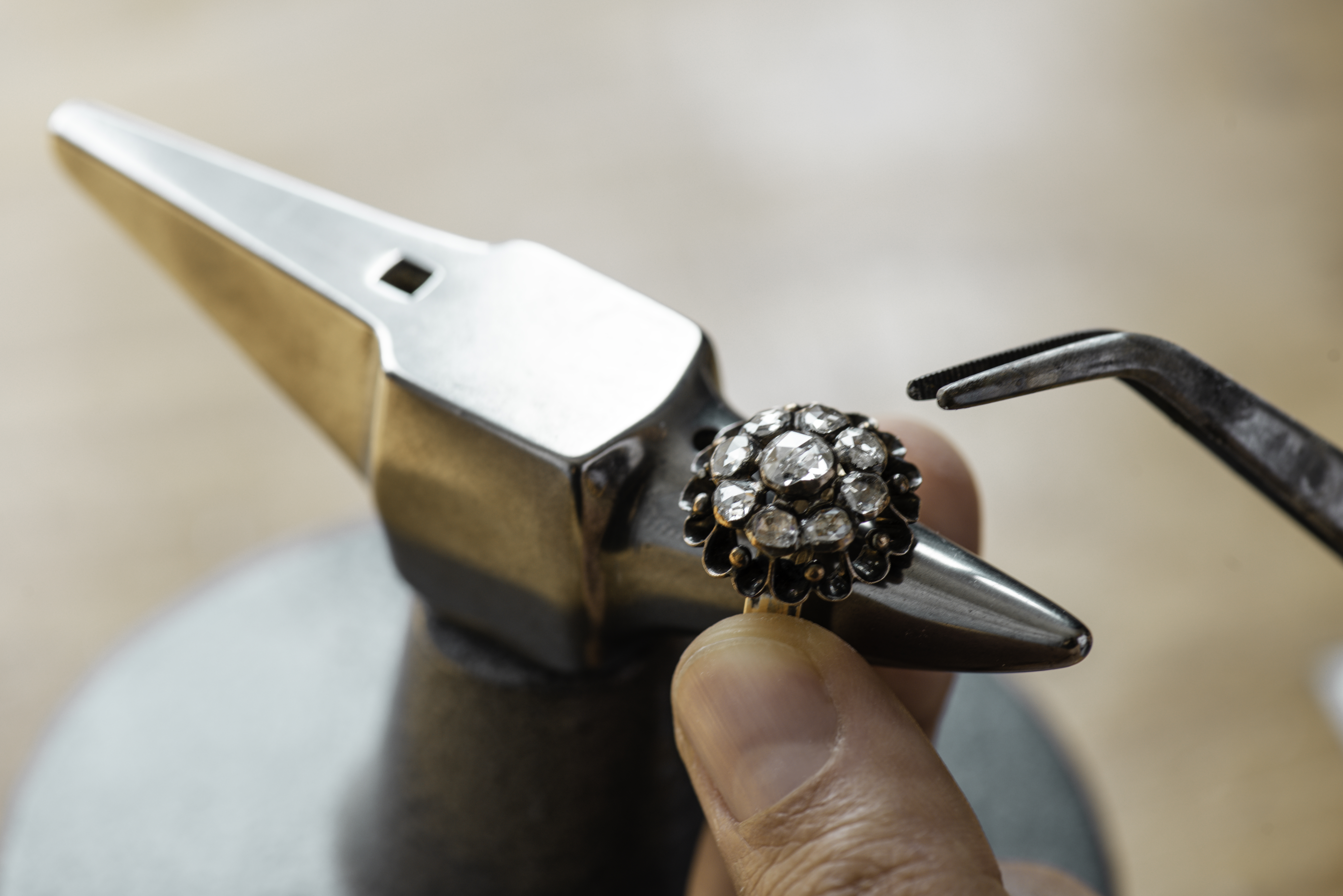 person repairing jewlery in shop